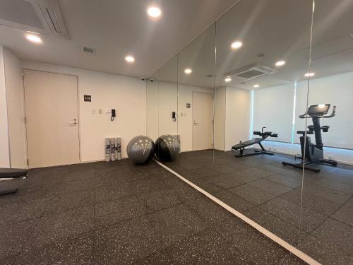 a room with a mirror and some exercise equipment at Sotetsu Grand Fresa Saigon in Ho Chi Minh City
