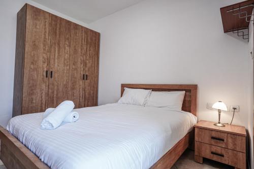 a bedroom with a bed with a white pillow on it at Shoham Sea and Soul in Eilat