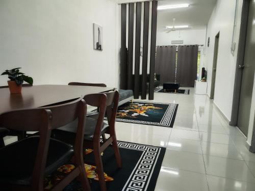 a dining room with a table and some chairs at Homestay Temerloh Near Hospital 4Bedroom 4Air-cond 10pax Free Wi-Fi Netflix in Temerloh