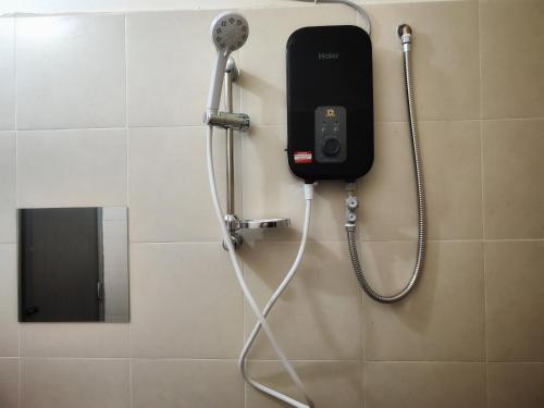 a phone hanging on a wall in a bathroom at Homestay Temerloh Near Hospital Wi-Fi Netflix in Temerloh