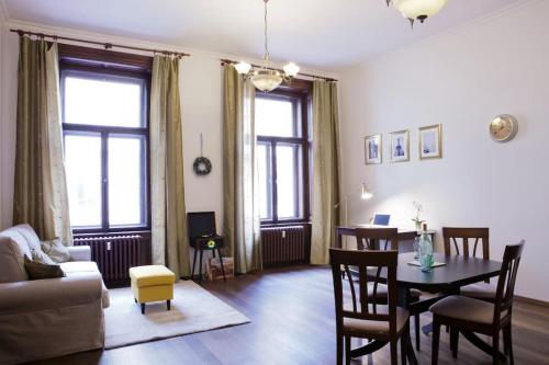 a living room with a table and a dining room at Rhythm and style in Prague city center Andel in Prague
