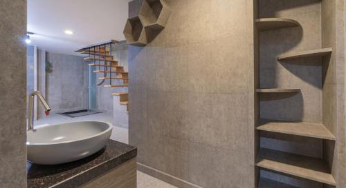 a bathroom with a white bowl sink and a staircase at Hinokki Haesuzzim Resort in Geoje 