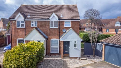 a brick house with a white door at The Pastures Lodge in Stevenage