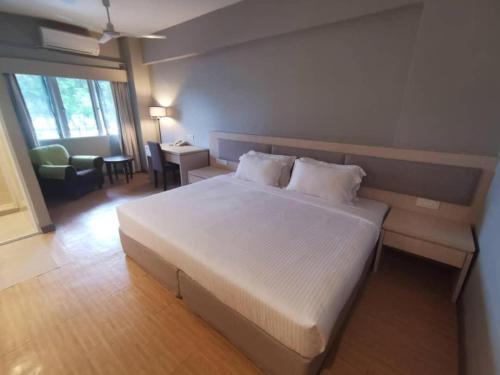 a bedroom with a large white bed in a room at Reka Hotel Genting Highlands in Genting Highlands