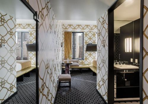a bathroom with two sinks and a large mirror at 45 Times Square Hotel in New York