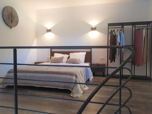 a bedroom with a bed with a metal frame at T1 bis avec mezzanine, belle terrasse et jardinet. in Moncale
