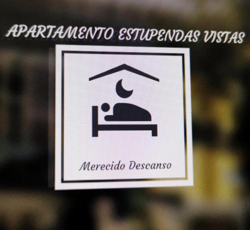 a sign for a hospital with a person on a bed at Apartamento con estupendas vistas in Moaña