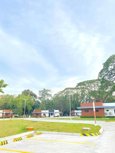 a park with a building and a field with trees at Aurora Villas and Cabin Resort in Clark