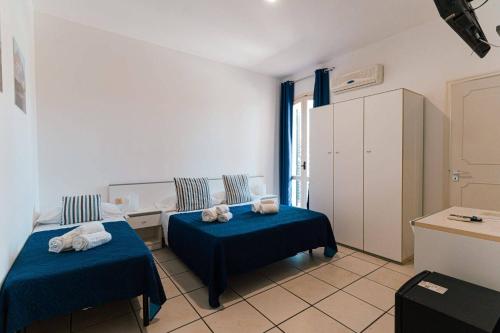 Postel nebo postele na pokoji v ubytování Hotel Le Dune