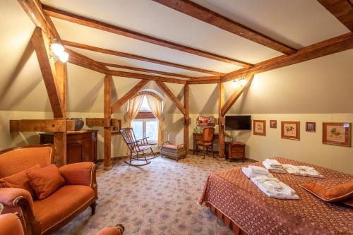 a bedroom with a bed and a couch in a room at Willa Barbara - ProHarmonia in Lądek-Zdrój