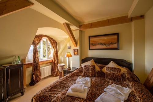 a bedroom with a bed with two towels on it at Willa Barbara - ProHarmonia in Lądek-Zdrój