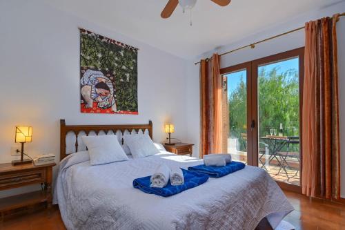 a bedroom with a large bed and a sliding glass door at Casa Julieta in Jávea