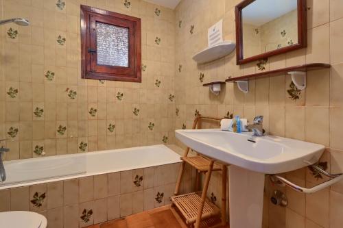 a bathroom with a sink and a tub and a toilet at Casa Julieta in Jávea