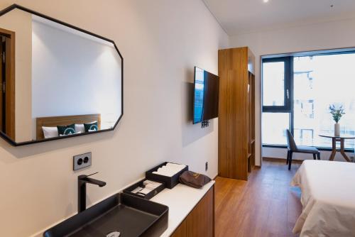 a bathroom with a sink and a mirror at Hotel Arari in Jeonju