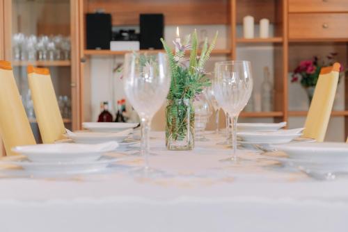 a table with wine glasses and plates on it at Propodes Luxury Villa in Pastida