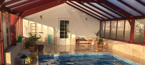 a house with a swimming pool in a room at Kastanjegården på Stenshuvud in Kivik
