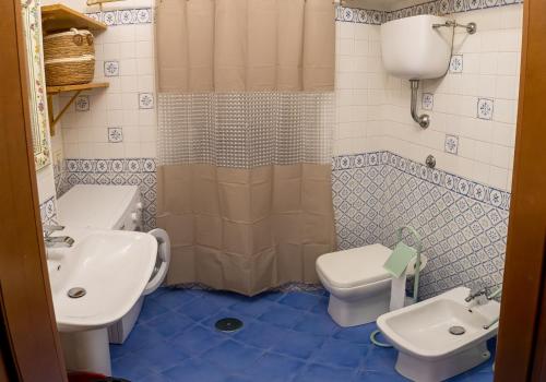 a bathroom with a sink and a toilet and a shower at BIANCAROSA in Viterbo
