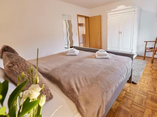 a bedroom with a bed with two towels on it at Die Landgräfinnen Ferienwohnung in Schwalmstadt
