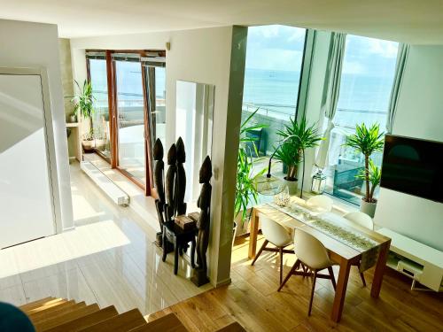 a living room with a table and a view of the ocean at SEA TOWERS PENTHOUSE 23-24 Two-Floors Sea View Panoramic Terrace 110m2 !!! jacuzzi in Gdynia