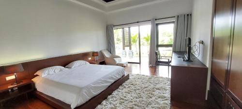 Ένα ή περισσότερα κρεβάτια σε δωμάτιο στο Villa Ventura