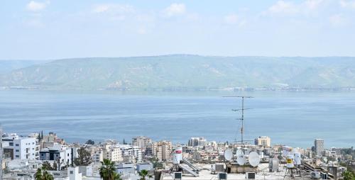 a city with a large body of water and buildings at Kineret sheli- 4Bedrooms luxury apartment with stunning lake view in Tiberias
