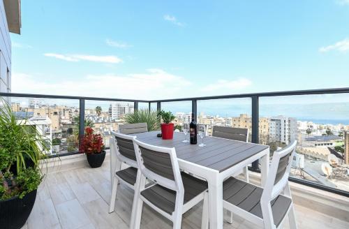 a white table and chairs on a balcony with a view at Kineret sheli- 4Bedrooms luxury apartment with stunning lake view in Tiberias