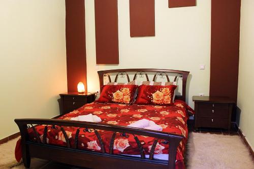 a bedroom with a bed with red sheets and red pillows at Snow story 1 -Elati, Trikala-2BD in Elati