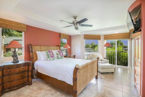 a bedroom with a bed and a ceiling fan at Nohea Villa in Princeville