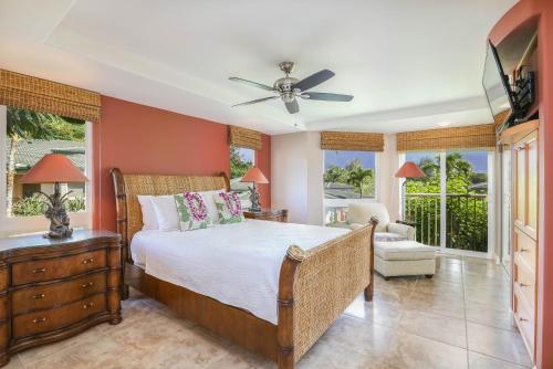 a bedroom with a bed and a ceiling fan at Nohea Villa in Princeville