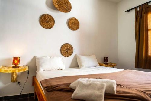 a bedroom with a bed and some mirrors on the wall at Casa Mara Dakar in Dakar