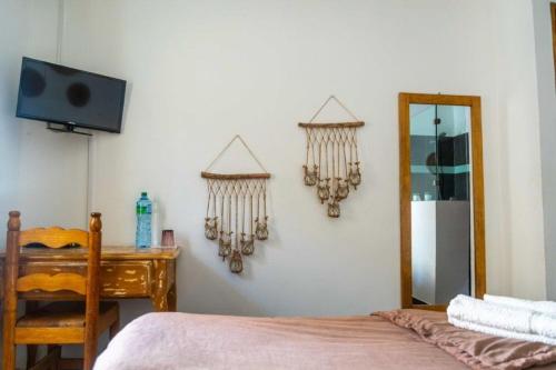 a bedroom with a bed and a desk and a mirror at Casa Mara Dakar in Dakar