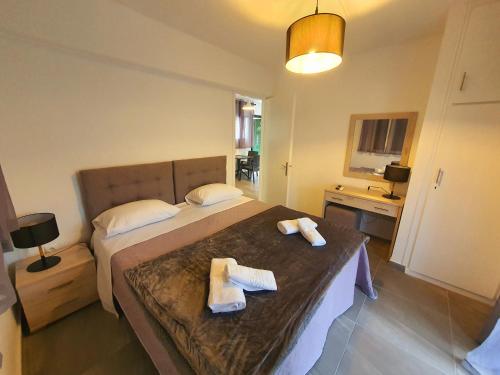 a hotel room with two towels on a bed at BELLA DE LUX RESIDENCE in Kato Korakiana