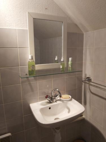 a bathroom with a sink and a mirror at Chambre privée +thé et café 