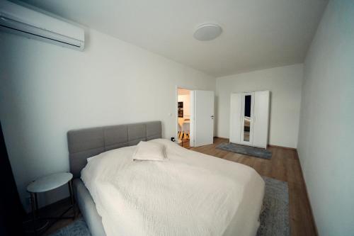 1 dormitorio con 1 cama blanca en una habitación en TIFFANY Apartment Hotel en Bratislava