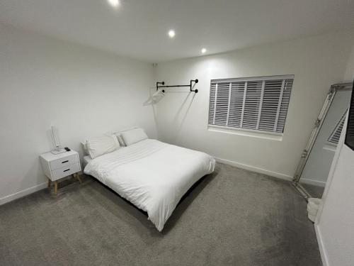 a white bedroom with a bed and a window at Unique New 4 Bedroom House, HS2, Business People, Contractors & Families in Minworth