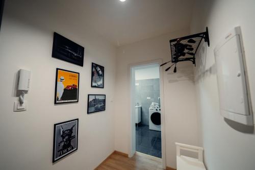 a hallway with pictures on the walls of a house at TIFFANY Apartment Hotel in Bratislava