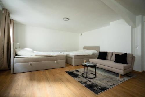 een woonkamer met twee bedden en een bank bij Oldtown Studio Apartment with 2 Bathrooms in Düsseldorf