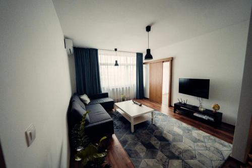 a living room with a couch and a tv at TIFFANY Apartment Hotel in Bratislava