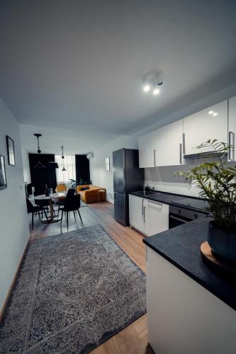 a kitchen and living room with a table in it at TIFFANY Apartment Hotel in Bratislava