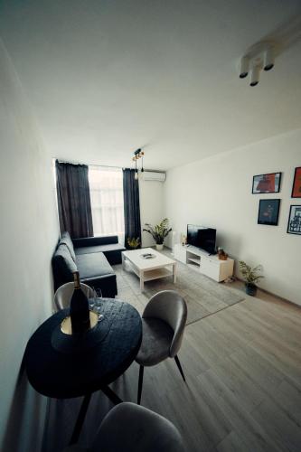 a living room with a table and a couch at TIFFANY Apartment Hotel in Bratislava