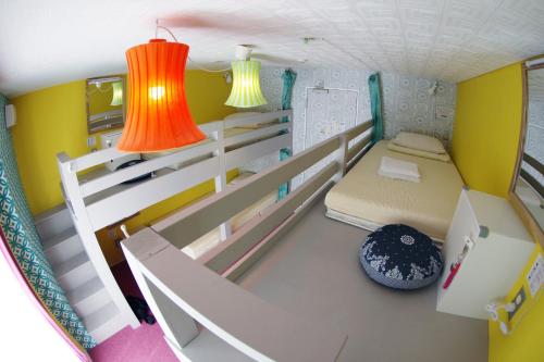 a small room with two bunk beds and two lights at Ten to Sen Guesthouse in Takamatsu