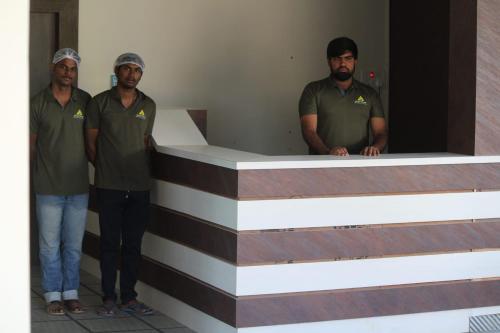 a group of men standing in front of a table at Hotel Prime Classic in Shamshabad