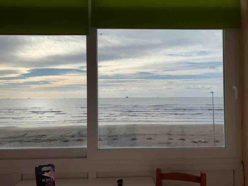 a view of the beach from a window at Beautiful Sea View Apartment in Durrës