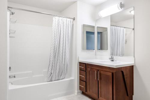 a bathroom with a tub and a sink and a shower at Playa del Rey 1BR w WD Gym Pool nr beach LAX-412 in Los Angeles