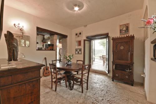 a dining room with a table and a wooden cabinet at Agriturismo Fontenuova in Saturnia