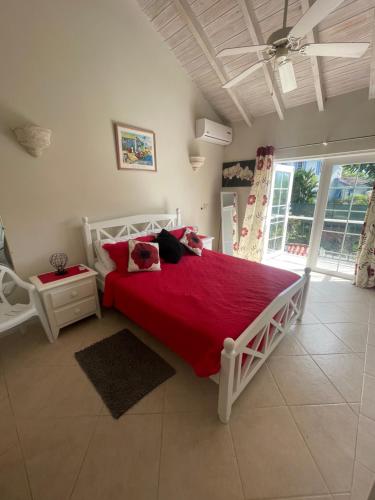 a bedroom with a large bed with a red blanket at Nanpa, Luxury Family Three Bed Villa, St James West coast, Private pool in Saint James