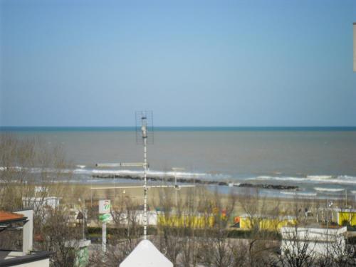 a view of a beach with the ocean in the background at Hotel Busignani in Rimini