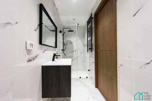 a bathroom with a sink and a mirror at Sunset 204 Luxury 2bds with Gym in Tunis