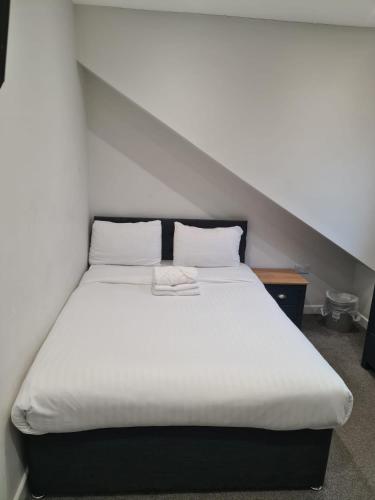 a bedroom with a large white bed in a attic at APARTMENT in BARNSLEY CENTRAL in Barnsley