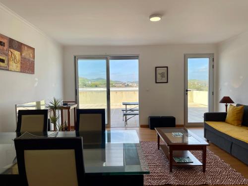 a living room with a couch and a table at Ocean Terrace House in Ribeira Grande